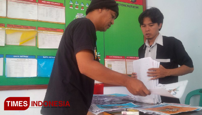 Ken Ali (kiri) dan Aji menilai hasil lomba mewarnai pahlawan Blambangan di Kantor Desa Pesanggaran, Kecamatan Pesanggaran, Kabupaten Banyuwangi. (FOTO: Ahmad Suudi/TIMES Indonesia)