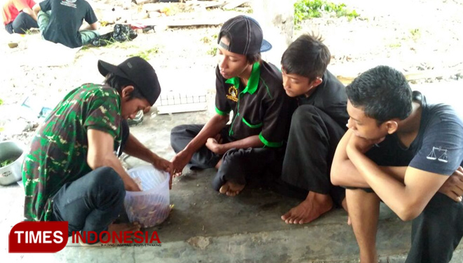 Pemuda tani asal Lamongan saat membuat fermentasi air kencing kelinci dan pupuk organik, Sabtu, (7/4/2018). (FOTO: Ardiyanto/TIMES Indonesia)