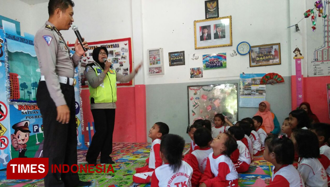 Anggota Satlantas Polres Jember bercerita tentang pentingnya tertib saat berlalu lintas kepada anak-anak PAUD Pelangi Citra Nusantara. (FOTO: Siti Mukifah/TIMES Indonesia)