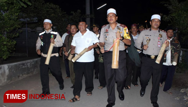 Kapolres Probolinggo (tengah kopyah putih) saat menabuh tradisi musik kentongan bangunkan warga untuk sahur.(FOTO: Dicko W/TIMES Indonesia)