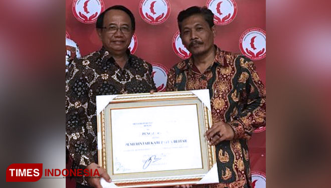 Bupati Blitar Rijanto didampingi Kabag Hukum Pemkab Blitar menerima piagam penghargaan Kabupaten Peduli HAM 2018
