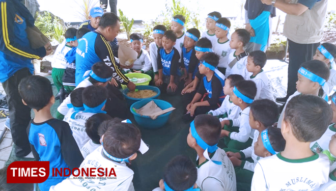 Anggota Tagana Dinsos P3A Ponorogo mengajari anak-anak PAUD cara membungkus nasi untuk korban bencana. (FOTO: Evita Mukharohmah/TIMES Indonesia)