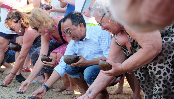 Guests of the griya santrian beach resort participated in the release of baby turtles (tukik). (PHOTO:  Special)