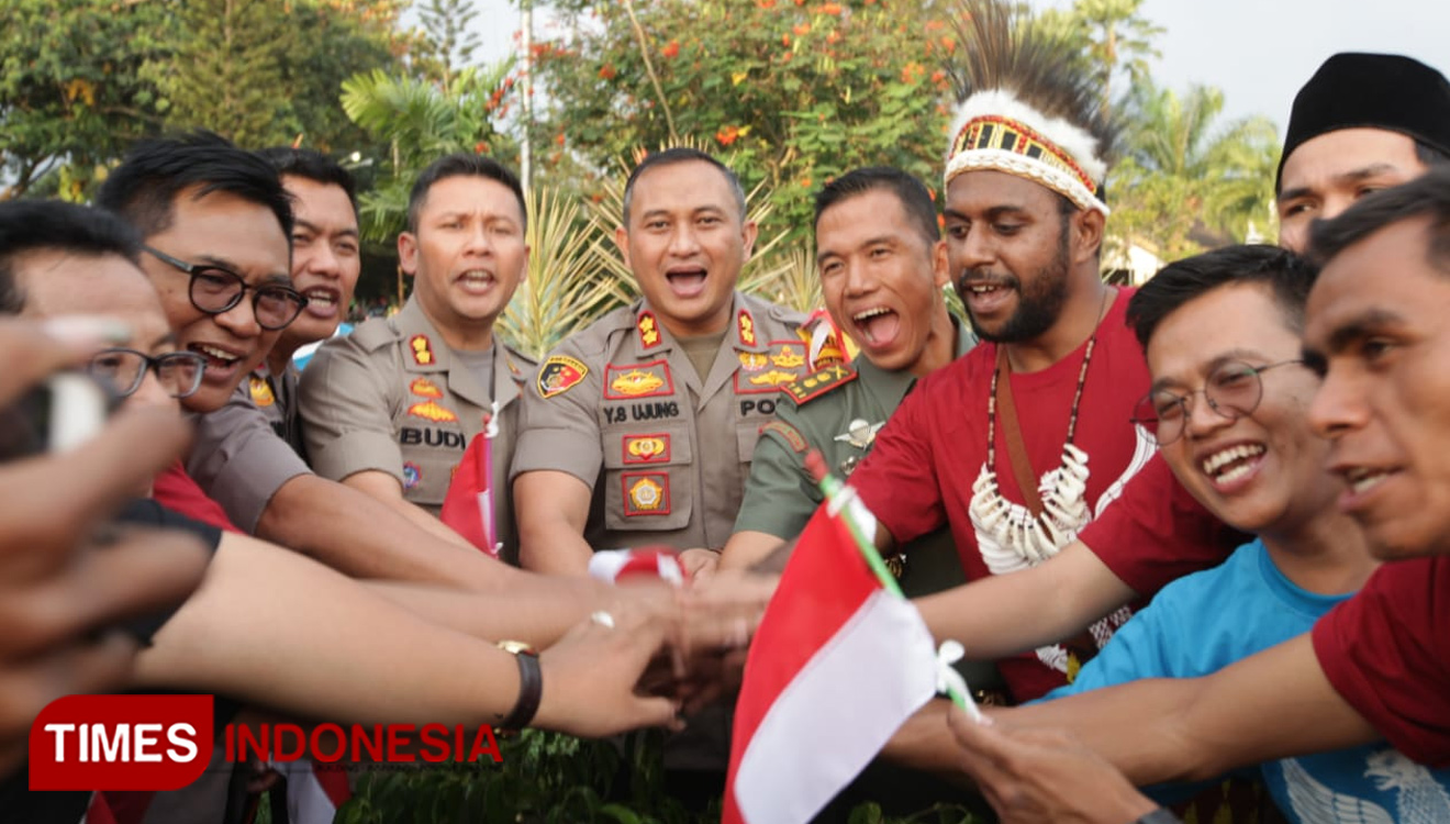 The smile of the policeman and the Papua youth at the Bhinneka Tunggal Ika Indah event. (Picture by: Adhitya Hendra/TIMES Indonesia)