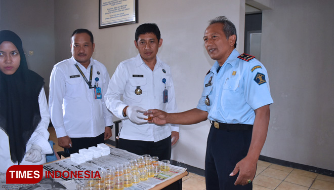 Kepala Rupbasan Kelas II Blitar ( Kanan) menyerahkan sample urine kepada Kepala BNN Kabupaten Blitar, Selasa ( 12/11/2019). (FOTO: Sholeh/ TIMES Indonesia)