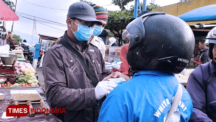 Para relawan saat membagikan hand sanitizer di Pasar Besar Kota Batu. (Foto: MDMC Kota Batu for TIMES Indonesia)