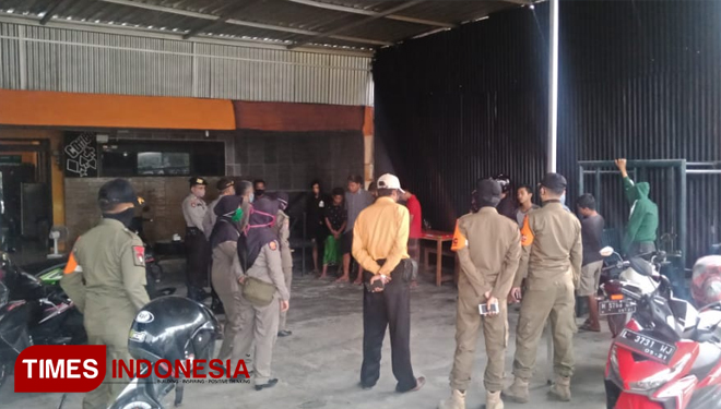 Polisi dan Satpol PP saat melakukan pembubaran puluhan pemuda nongkrong sembari ngopi di Bulan Puasa di cafe Desa Buddagan, Kecamatan Pademawu.(Foto: Akhmad Syafi'i/TIMES Indonesia)