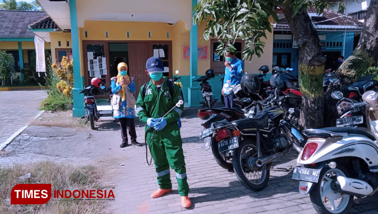 Petugas Puskesmas Guntur menyemprot disinfektan di fasilitas umum di Guntur, Kabupaten Demak, Jumat (26/6/2020). (foto: Agus Romli/TIMES Indonesia) 