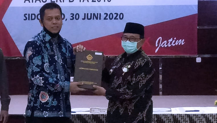 Bupati Blitar (Kanan) menerima penghargaan WTP dari BPK RI di kantor BPK Perwakilan Jawa Tmur di Surabaya, Selasa (30/6/2020). (Foto: Kominfo Kab Blitar) 