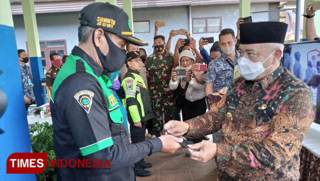 Bupati Malang, HM Sanusi saat memberikan masker secara simbolis untuk mendukung gerakan bermasker. (Foto: Binar Gumilang/TIMESI Indonesia)