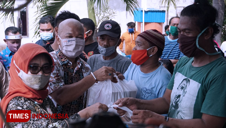 Manager CSR Pupuk Kaltim, Fakhri Husaini dan Wali kota Bontang,  Neni Moerniaeni saat menyerahkan bantuan simbolis kepada salah satu korban kebakaran. (Foto: Kusnadi/TIMES Indonesia)