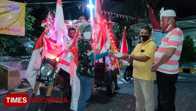 Pengurus RW 08 RMB Surabaya membagikan nasi kotak ke rumah warga menggunakan odong-odong, Minggu (16/8/2020).(Foto: Lely Yuana/TIMES Indonesia)