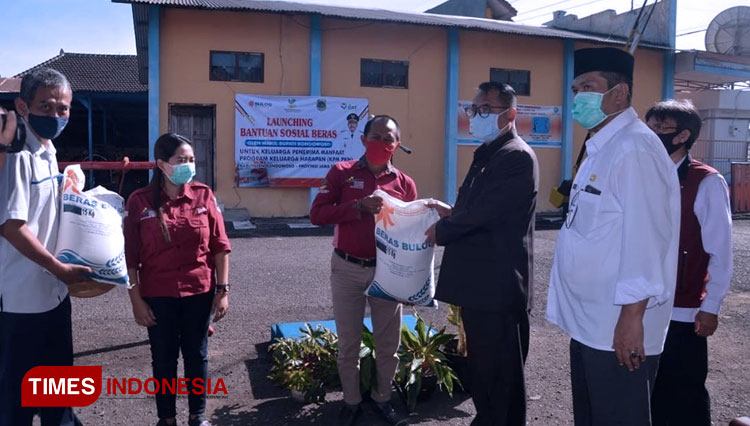 Wakil Bupati Bondowoso Irwan Bachtiar Rahmat, saat menyerahkan bantuan sosial beras kepada KPM PKH. (FOTO: Moh Bahri/TIMES Indonesia).