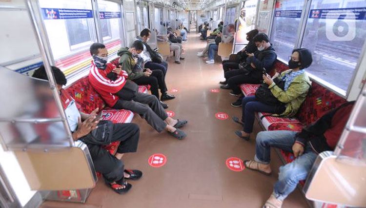 ILUSTRASI: Penumpang menerapkan jaga jarak aman saat duduk dalam gerbong KRL. (FOTO: Merdeka)