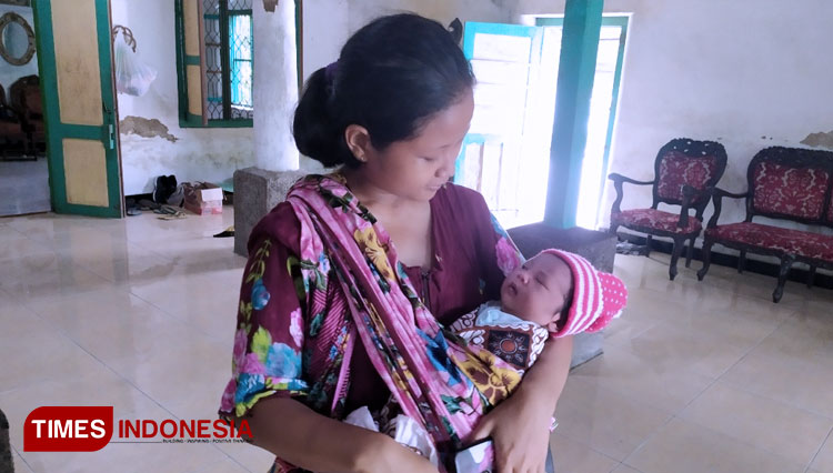 Istri Ponari saat menggendong buah hatinya dikediamannya Desa Sukosari, Jogoroto Jombang (Foto: Rohmadi/TIMES Indonesia)