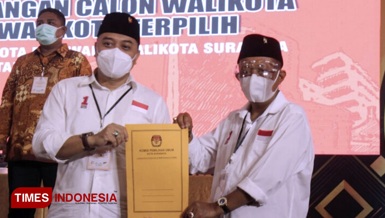 Eri Cahyadi dan Armuji menunjukkan berkas kemenangan Pilwali Surabaya 2020 dari KPU. (FOTO: Ammar Ramzi/ TIMES Indonesia)