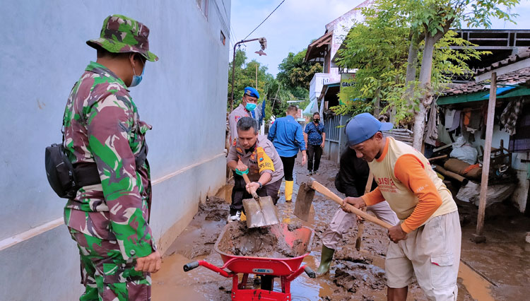 Kapolres Probolinggo AKBP Ferdy Irawan bersama TNI bersihkan lumpur pascabanjir.(FOTO: Humas Polres Probolinggo for TIMES Indonesia)