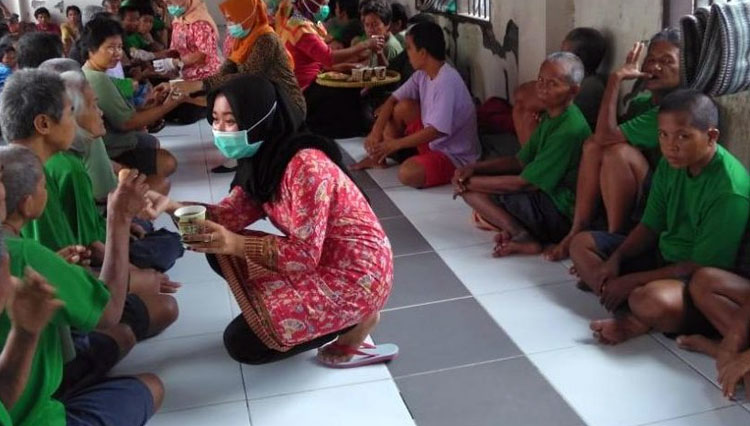 Petugas memberi asupan makan pada penghuni Liponsos Surabaya. (Foto: dok. Humas Pemkot Surabaya)