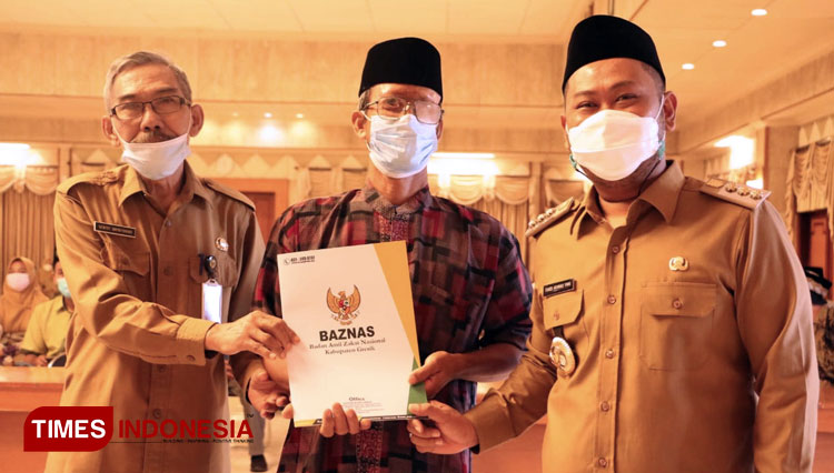 Bupati Gresik Fandi Akhmad Yani saat memberikan simbolis bantuan JPS kepada guru ngaji (Foto: Akmal/TIMES Indonesia).