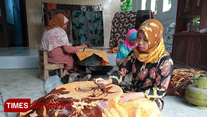 Sri Wahyuni Fatmawati (36) pengrajin Batik tulis asal Dusun Arsojih, Desa Pagendingan, Galis, Pamekasan saat membatik di halaman rumahnya.(Foto:Akhmad Syafi'i/TIMES Indonesia)