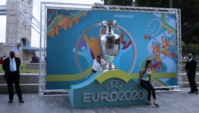 Warga berpose dengan logo Piala Eropa 2020 saat peluncuran di London, Inggris, 21 September 2016. UEFA memundurkan jadwal Piala Eropa 2020 hingga tahun 2021. (AP Photo/Tim Ireland, File)