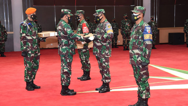 Panglima TNI Marsekal TNI Hadi Tjahjanto menyerahkan Laptop secara simbolis kepada para prajurit yang akan menjadi petugas tracer Covid-19, Selasa (27/7/2021). (foto: Puspen TNI)