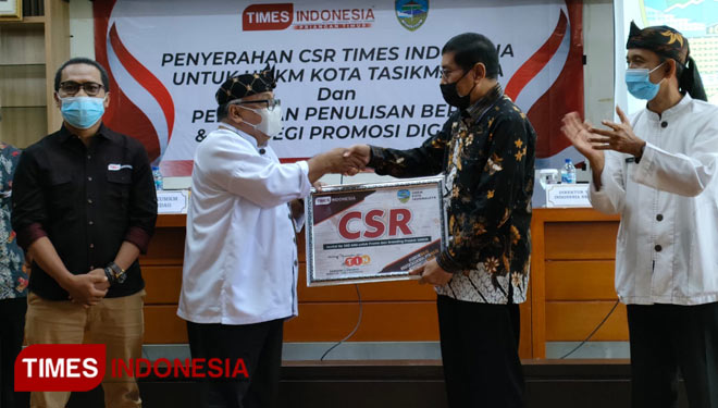 Wali Kota Tasikmalaya H Muhamad Yusuf (berbatik) memberikan CSR  dari TIMES Indonesia kepada Kepala Dinas Koperasi UMKM dan Perindag di Aula Pemerintah Kota Tasikmalaya, Kamis (7/10/21) (FOTO: Harniwan Obech/TIMES Indonesia)